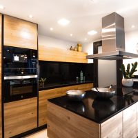 Minimalist kitchen island with premium acrylic countertops, frequently specified by B2B contractors for its repairability and style.