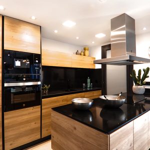 Minimalist kitchen island with premium acrylic countertops, frequently specified by B2B contractors for its repairability and style.