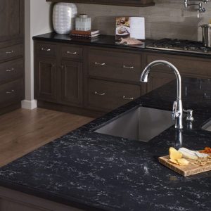 Detailed view of durable custom granite countertops with a stainless steel sink, highlighting the texture of natural stone.